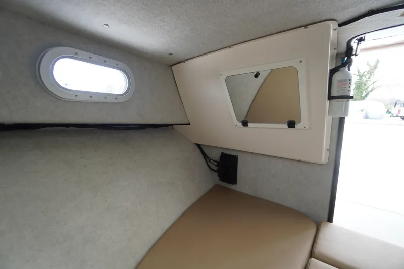 Slide: The Image of Interior cabin of 2018 May-Craft 2700 Pilot XL boat with window and fire extinguisher. - 26