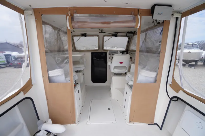 Slide: The Image of Interior of a 2018 May-Craft 2700 Pilot XL boat with seating and navigation equipment. - 4