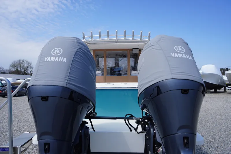 Slide: The Image of 2018 May-Craft 2700 Pilot XL with twin Yamaha outboard motors, docked under a clear sky. - 40