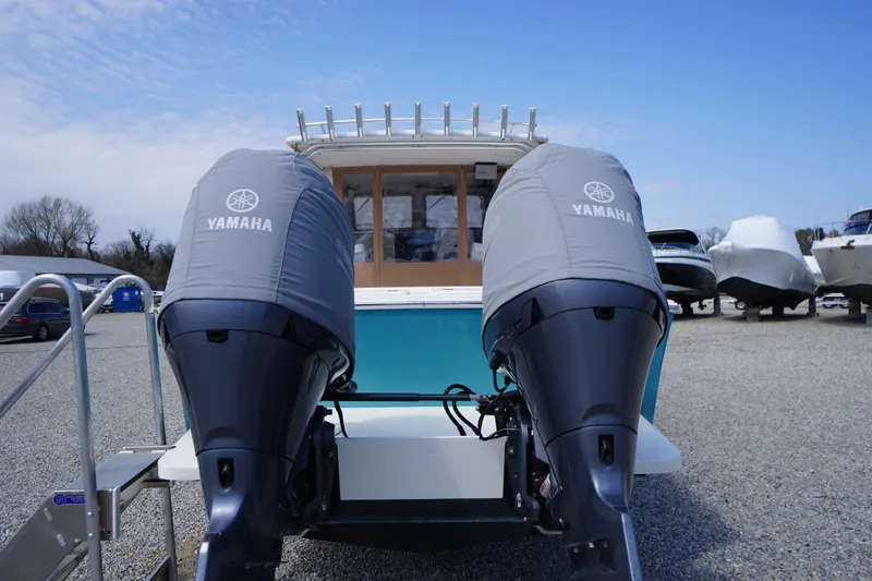 Slide: The Image of 2018 May-Craft 2700 Pilot XL with twin Yamaha outboard motors in a boatyard. - 41