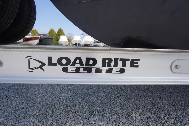 Slide: The Image of Load Rite Elite trailer for 2018 May-Craft 2700 Pilot XL boat on gravel. - 45