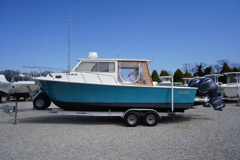 Slide: The Image of 2018 May-Craft 2700 Pilot XL boat on trailer, blue hull, dual outboard motors. - 46