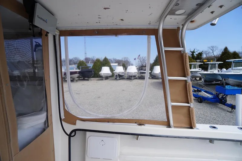 Slide: The Image of Interior view of a 2018 May-Craft 2700 Pilot XL boat, showing a ladder and window. - 5