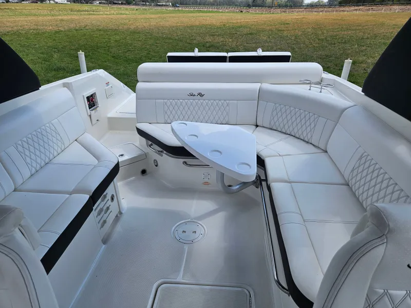 Slide: The Image of Interior of a 2021 Sea Ray SLX 280 with white leather seating and table. - 10