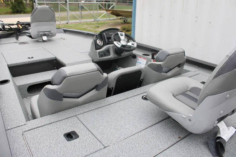 Slide: The Image of 2025 G3 Sportsman 1810 boat interior with gray seating and modern dashboard. - 10