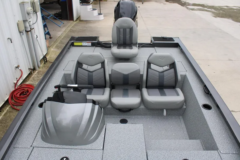 Slide: The Image of 2025 G3 Sportsman 1810 boat interior with gray seating and steering console. - 14