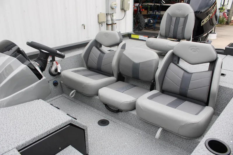 Slide: The Image of 2025 G3 Sportsman 1810 boat interior with gray seating and steering console. - 6