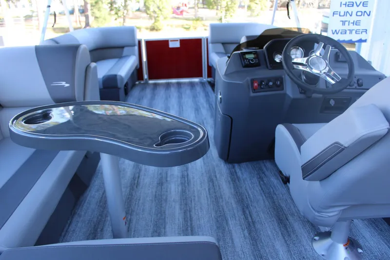 Slide: The Image of Interior of 2025 Bennington 20S pontoon boat with modern seating and steering console. - 11