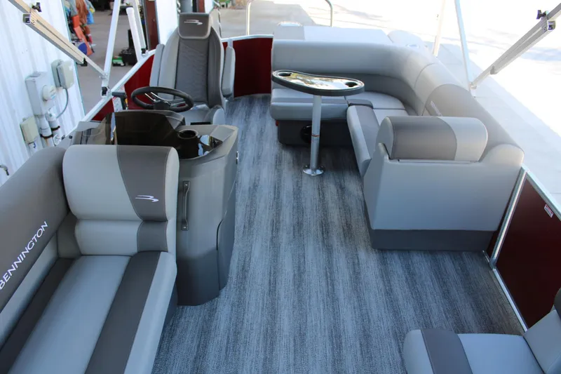 Slide: The Image of Interior of a 2025 Bennington 20S pontoon boat with modern seating and steering console. - 16