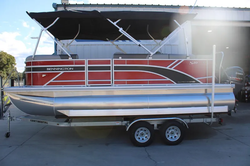 Slide: The Image of 2025 Bennington 20S pontoon boat with red and silver design on a trailer. - 4