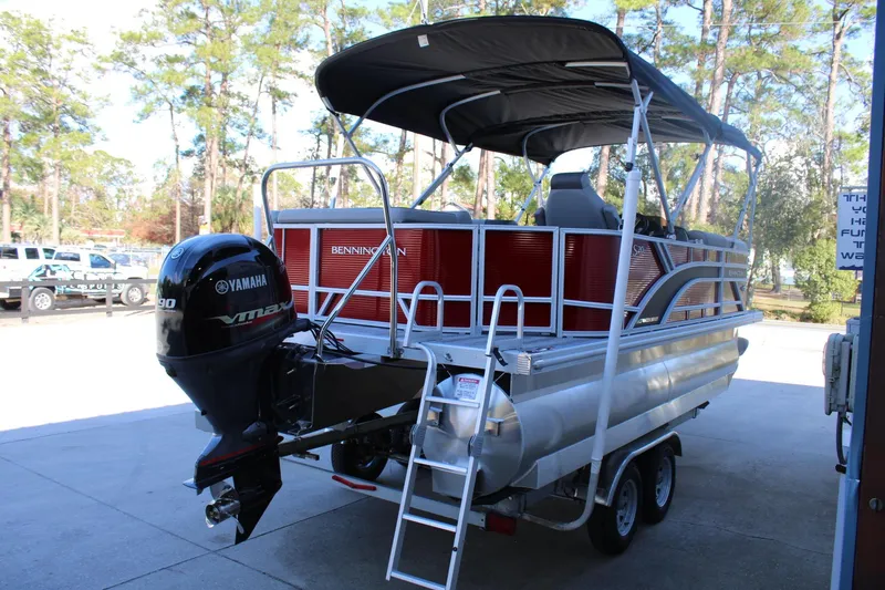 Slide: The Image of 2025 Bennington 20S pontoon boat with Yamaha VMAX engine, parked outdoors. - 8