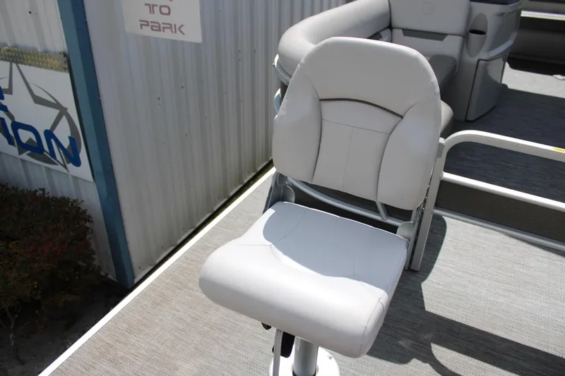 Slide: The Image of 2023 Godfrey Sweetwater 2286 BF boat seat, gray upholstery, outdoor setting. - 11
