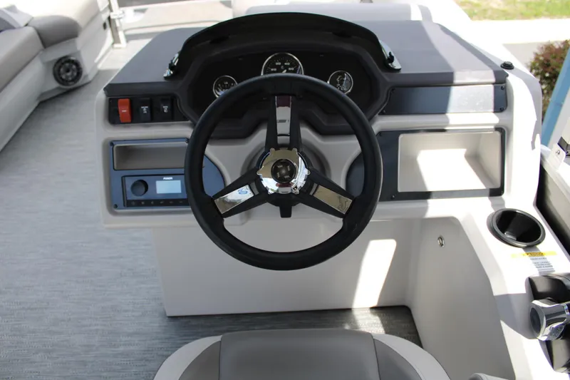 Slide: The Image of 2023 Godfrey Sweetwater 2286 BF boat dashboard with steering wheel and controls. - 13