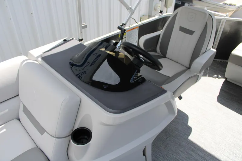 Slide: The Image of 2023 Godfrey Sweetwater 2286 BF boat interior with steering console and seating. - 14