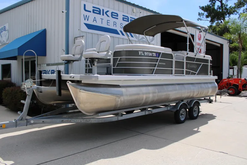 Slide: The Image of 2023 Godfrey Sweetwater 2286 BF pontoon boat on trailer outside dealership. - 2