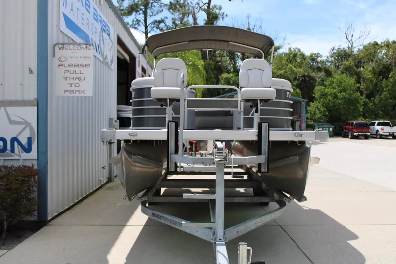 Slide: The Image of 2023 Godfrey Sweetwater 2286 BF pontoon boat on trailer, parked outside dealership. - 3