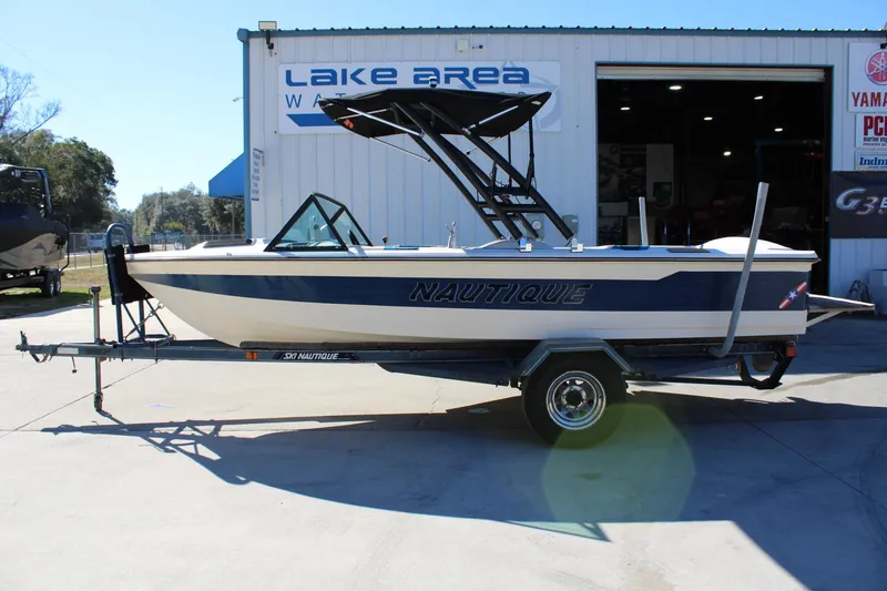 The Image of 1985 Correct Craft Ski Nautique boat on trailer outside Lake Area Watersports. - 1