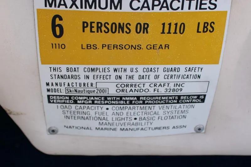 Slide: The Image of 1985 Correct Craft Ski Nautique capacity label, 6 persons or 1110 lbs, safety compliance. - 10