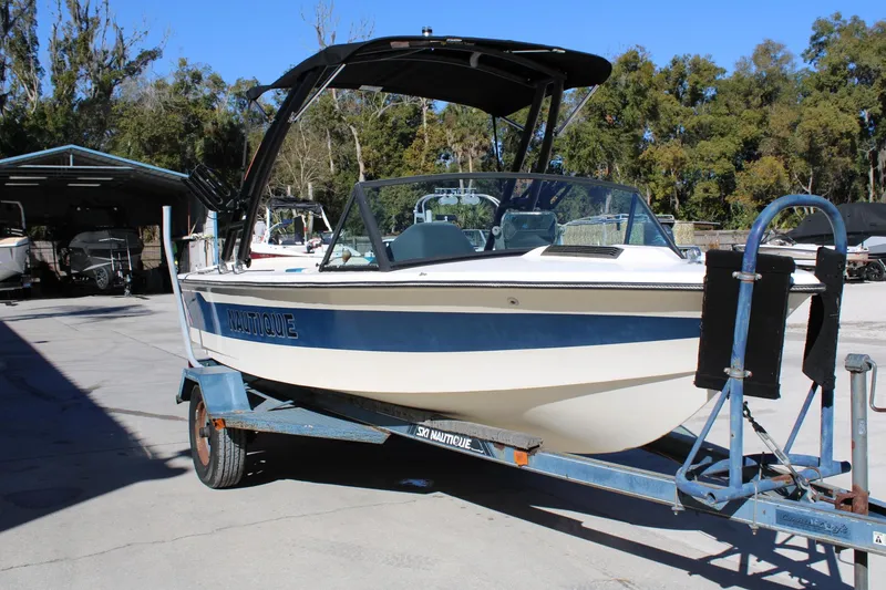 Slide: The Image of 1985 Correct Craft Ski Nautique boat on trailer, parked outdoors. - 4