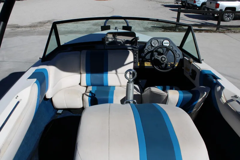 Slide: The Image of 1985 Correct Craft Ski Nautique interior with blue and white seating and dashboard controls. - 7