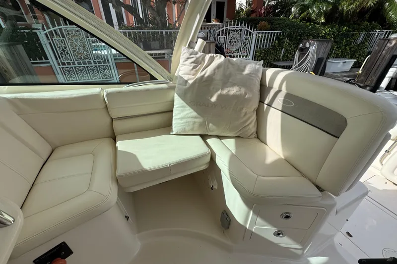 Slide: The Image of Luxurious seating area on a 2016 Grady-White Express 370 boat, featuring cream upholstery. - 10