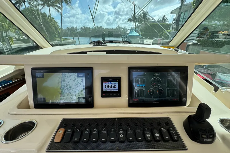 Slide: The Image of Dashboard of a 2016 Grady-White Express 370 boat with navigation screens. - 13