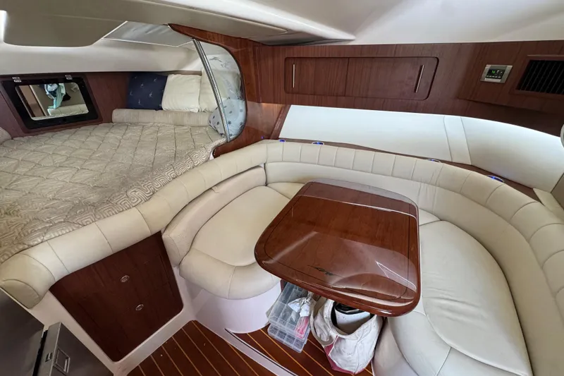 Slide: The Image of 2016 Grady-White Express 370 cabin interior with cozy seating and sleeping area. - 15