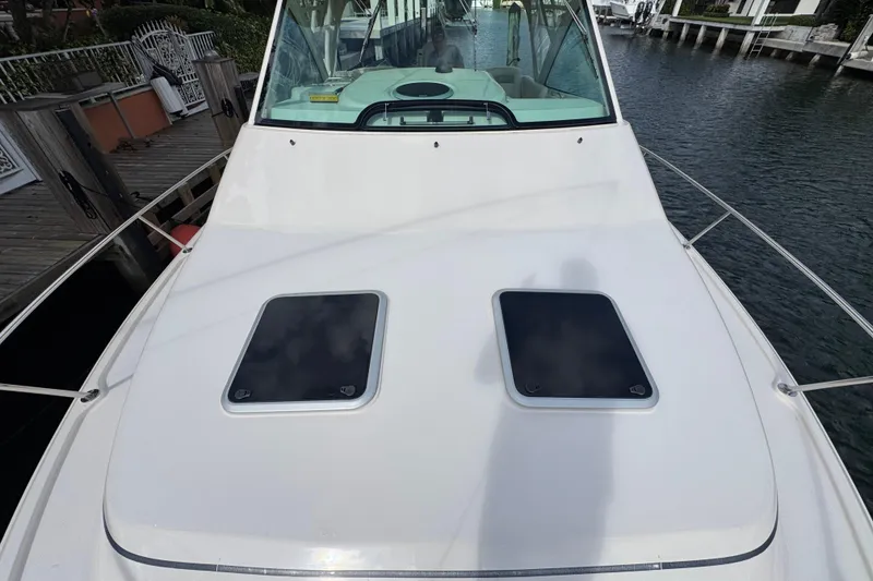 Slide: The Image of 2016 Grady-White Express 370 boat deck with dual hatches, docked by the water. - 19