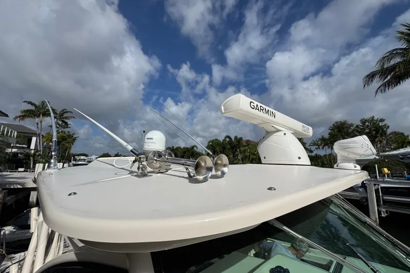 Slide: The Image of 2016 Grady-White Express 370 boat with Garmin radar, docked under a cloudy sky. - 22