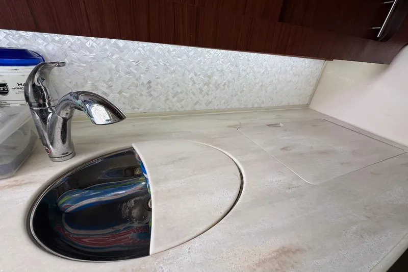 Slide: The Image of 2016 Grady-White Express 370 boat kitchen sink with chrome faucet and countertop. - 23