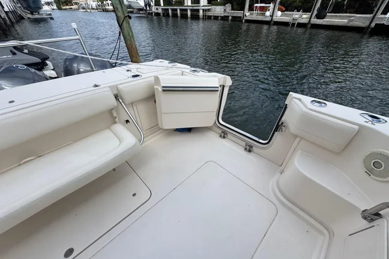 Slide: The Image of 2016 Grady-White Express 370 boat interior with seating and open transom door by the water. - 4