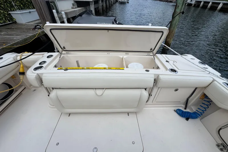 Slide: The Image of 2016 Grady-White Express 370 boat deck with open storage compartment by the water. - 7