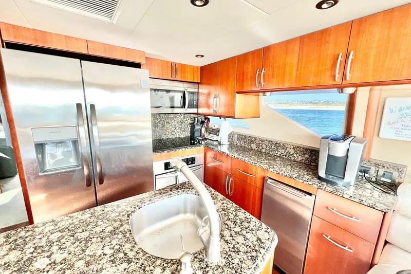 Slide: The Image of Luxurious kitchen interior of 2007 Lazzara 68 yacht with granite countertops and stainless steel appliances. - 18