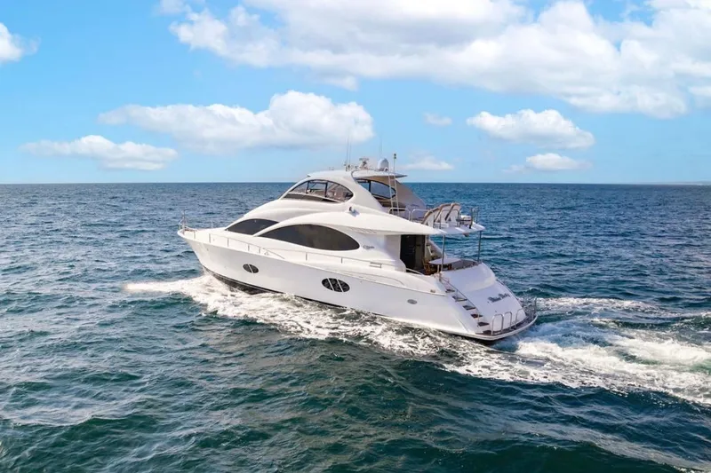 Slide: The Image of Luxurious 2007 Lazzara 68 yacht cruising on open sea under clear blue skies. - 2