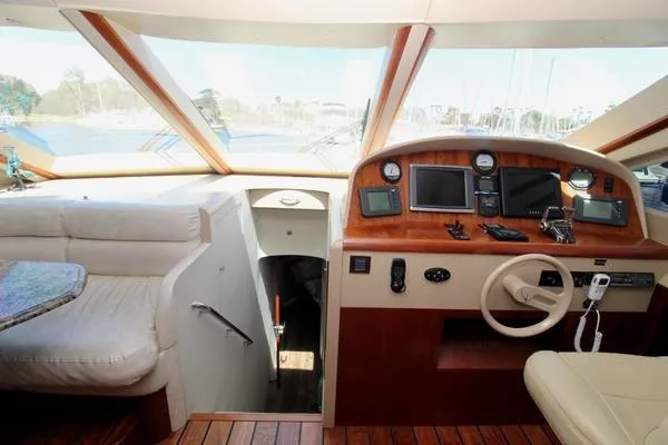 Slide: The Image of Luxurious 2007 Lazzara 68 yacht interior with helm, seating, and navigation equipment. - 20
