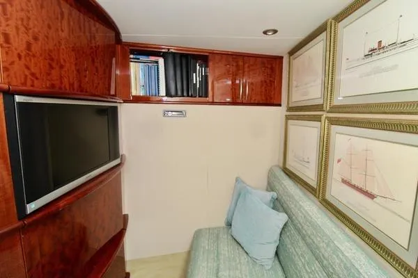 Slide: The Image of Luxurious interior of 2007 Lazzara 68 yacht with elegant wood finishes and framed artwork. - 21