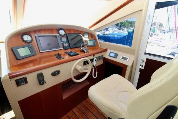 Slide: The Image of Helm of 2007 Lazzara 68 yacht with navigation instruments and leather seat. - 23