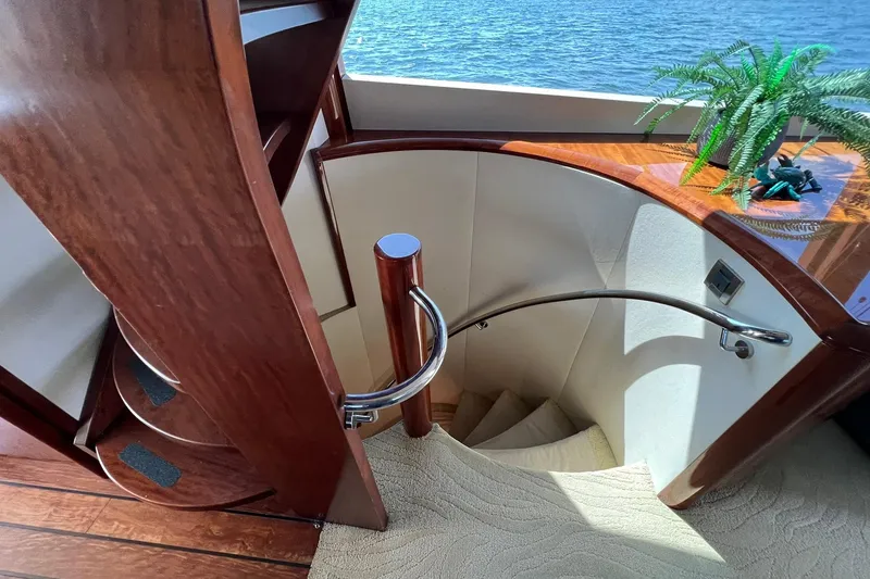Slide: The Image of Luxurious interior staircase on a 2007 Lazzara 68 yacht with elegant wood finish. - 28