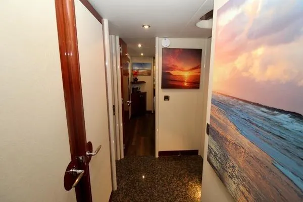 Slide: The Image of Hallway of 2007 Lazzara 68 yacht with ocean-themed artwork and elegant wood finishes. - 30