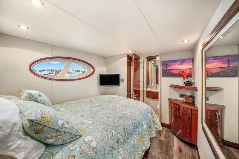 Slide: The Image of Luxurious 2007 Lazzara 68 yacht bedroom with elegant decor and scenic window view. - 34