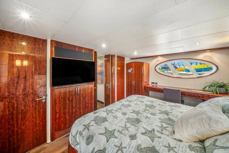 Slide: The Image of Luxurious 2007 Lazzara 68 yacht bedroom with elegant wood finishes and stylish decor. - 37