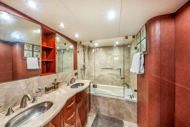 Slide: The Image of Luxurious bathroom in a 2007 Lazzara 68 yacht with dual sinks and elegant marble finishes. - 42