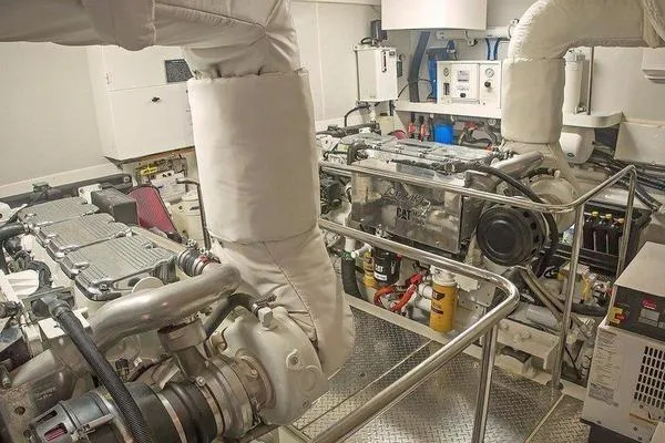Slide: The Image of Engine room of a 2007 Lazzara 68 yacht, featuring dual engines and mechanical equipment. - 45