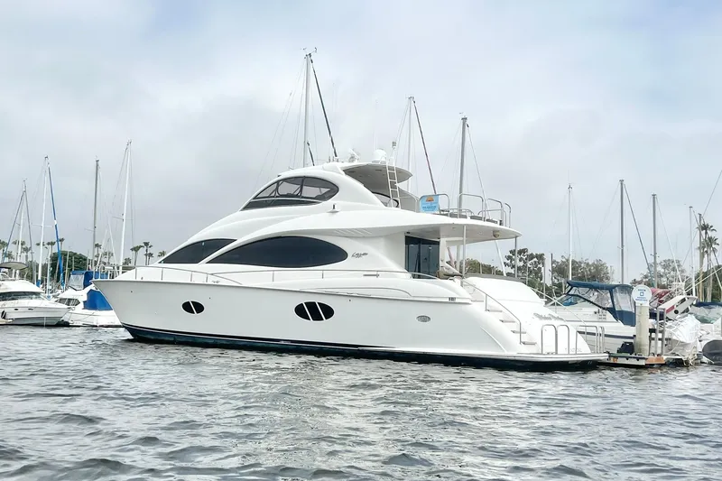 Slide: The Image of Luxury 2007 Lazzara 68 yacht docked in a marina, surrounded by sailboats. - 5