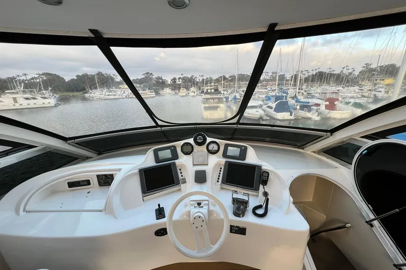 Slide: The Image of Helm of 2007 Lazzara 68 yacht with marina view, featuring navigation equipment. - 8