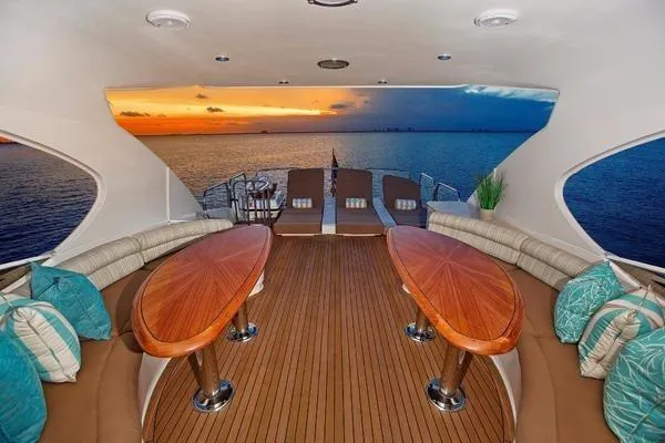 Slide: The Image of Luxurious 2007 Lazzara 68 yacht interior with sunset ocean view and elegant seating. - 9