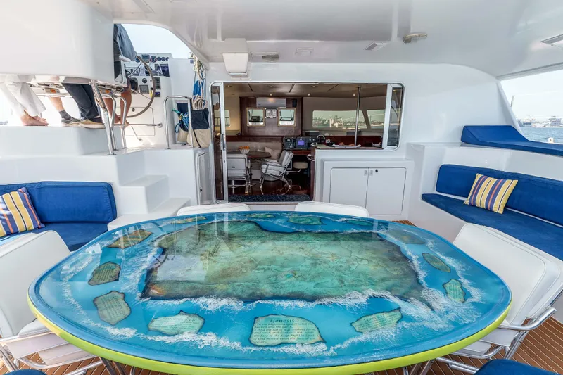 Slide: The Image of Luxurious 2009 Kelsall KSS 58 yacht interior with unique ocean-themed table and blue seating. - 11
