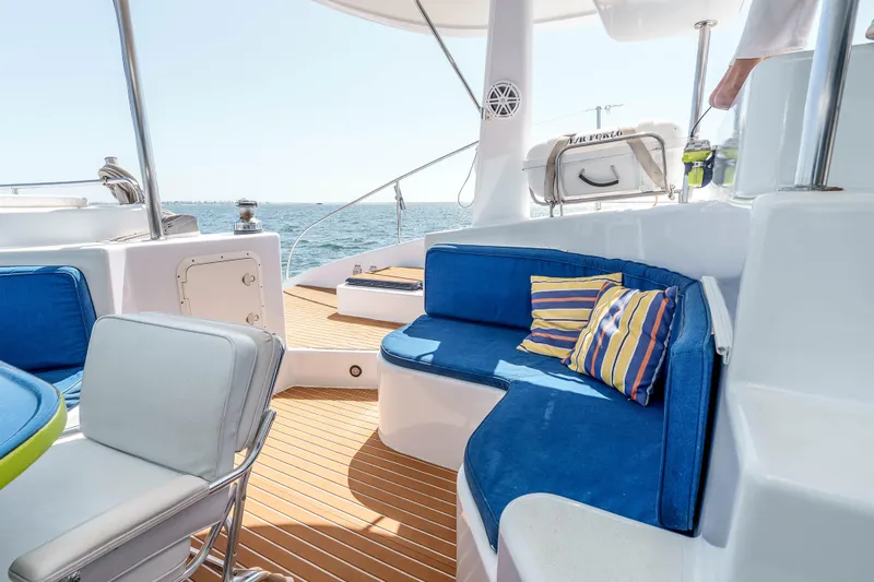 Slide: The Image of Luxurious 2009 Kelsall KSS 58 yacht deck with blue seating and striped cushions. - 13