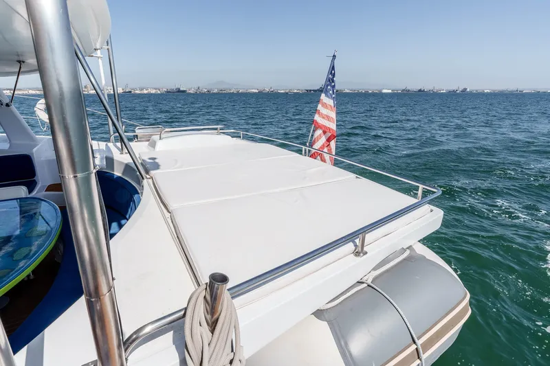 Slide: The Image of 2009 Kelsall KSS 58 yacht deck with American flag on open sea. - 14