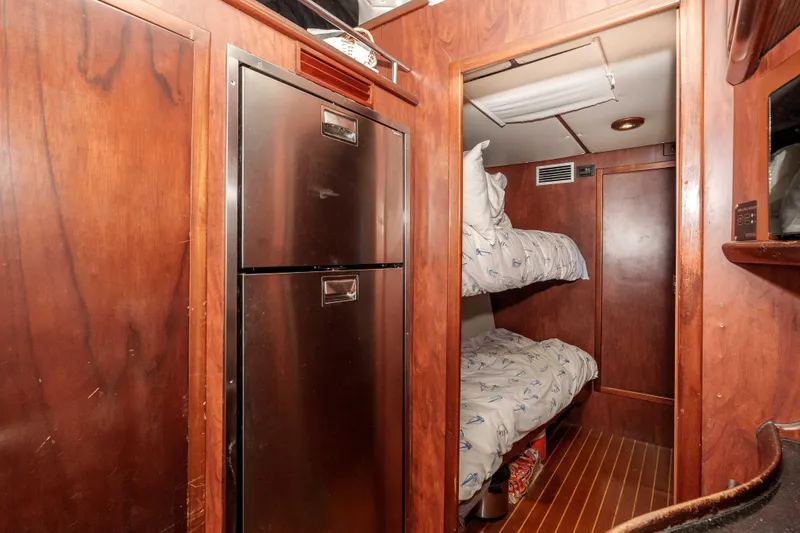 Slide: The Image of Interior of 2009 Kelsall KSS 58 yacht with bunk beds and stainless steel fridge. - 26